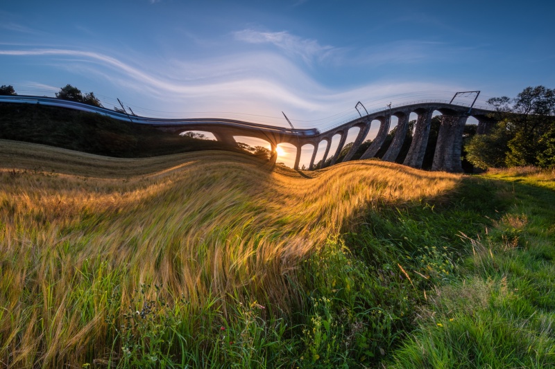 Deformazione dell'immagine - metamorfosi di un paesaggio con un ponte