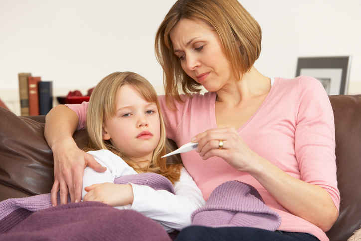 Una madre preoccupata misura la temperatura della figlia